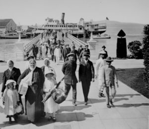 Historic photo of im mmigrants on Angel Island Pier